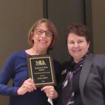 Cathy Chesher photo with Pletz Award plaque