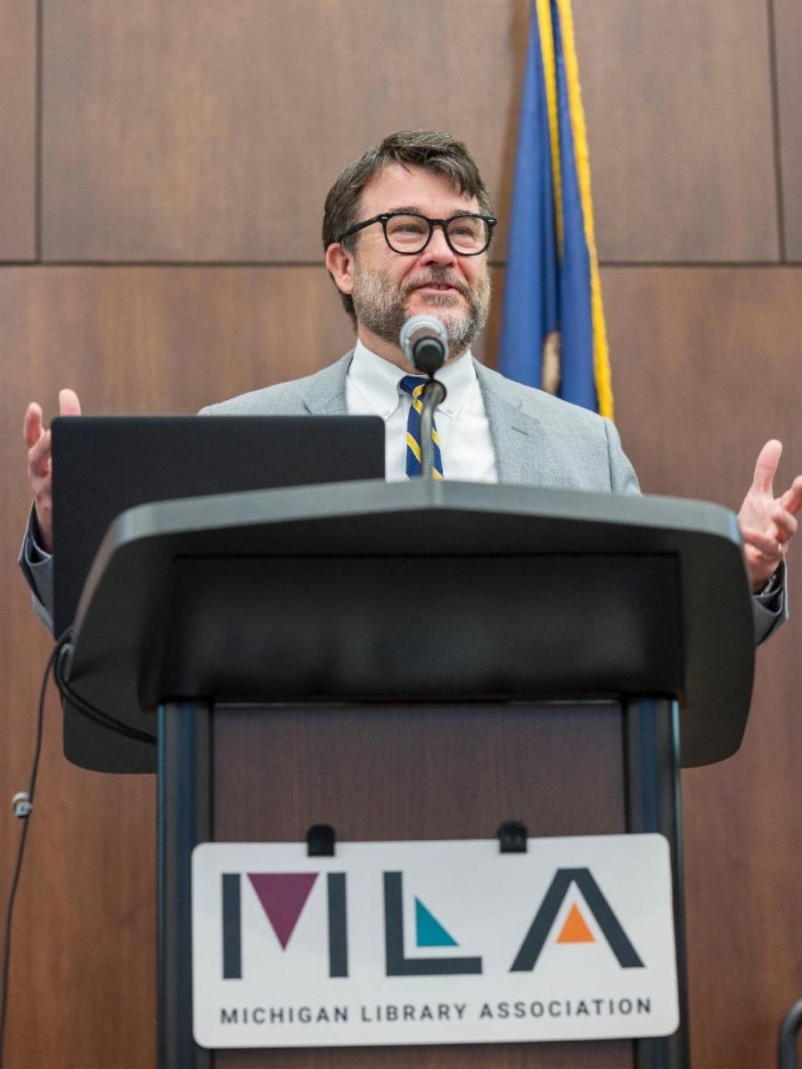 Randy Riley speaking at podium