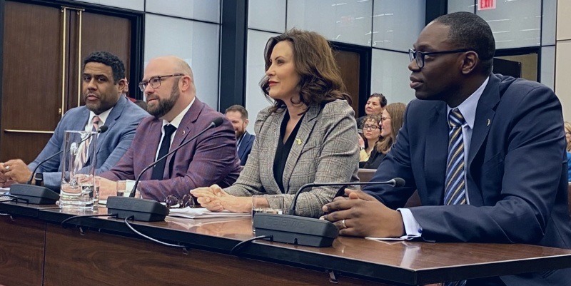 Gov. Whitmer, Lt. Gov. Gilchrist in a group discussing the state budget