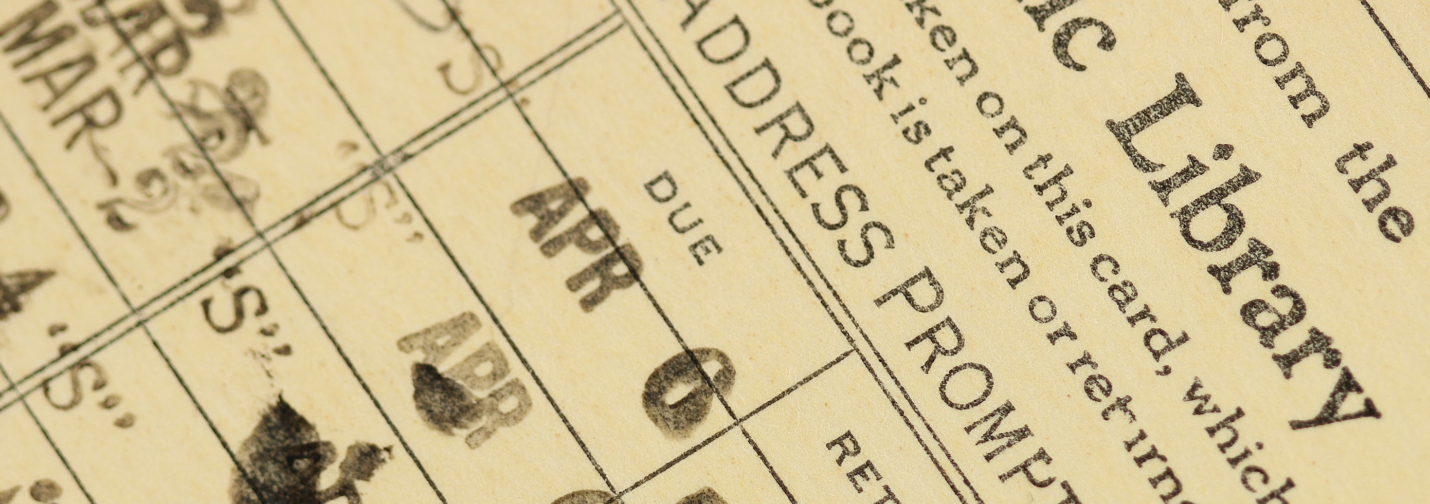 close up of library check out card with due dates